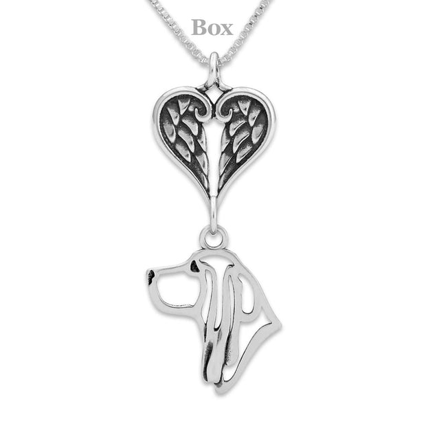 The Basset Hound memorial necklace consists of a sterling silver Basset Hound pendant suspended from a heart shaped sterling silver angel wing charm holder on a versatile box chain. The dog breed pendant is designed to breed standard.  Personalization is available on the reverse side.