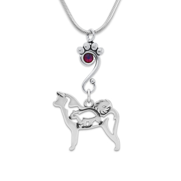 Sterling Silver Crystal Akita Necklace. A sterling silver paw print charm holder accented by an iridescent red and purple Volcano Swarovski holds a handcrafted Akita charm suspended from an elegant snake chain.