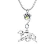 Sterling Silver Australian Shepherd Birthstone Necklace. A paw print charm holder accented by a light green Peridot Swarovski crystal holds an Australian Shepherd charm designed to breed standard. The handcrafted dog breed jewelry is suspended from a sleek snake chain.