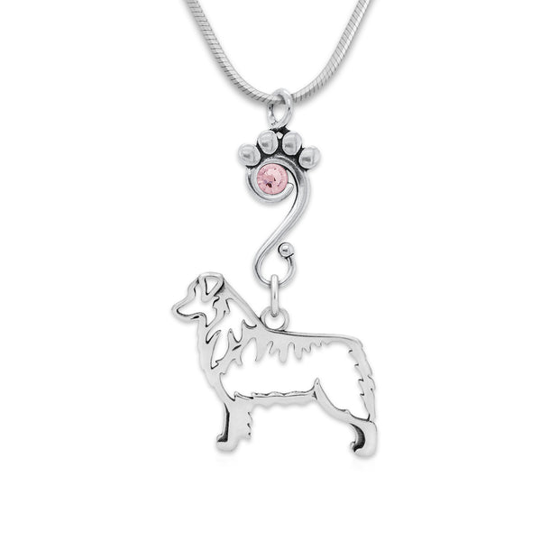 Sterling Silver Australian Shepherd Birthstone Necklace. A paw print charm holder accented by a light Amethyst Swarovski crystal holds an Australian Shepherd charm designed to breed standard. The handcrafted dog breed jewelry is suspended from a sleek snake chain.