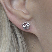 Paw Print and Heart Post Earrings in Sterling Silver on Model.