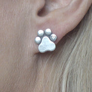 Paw Print Post Earrings with Heart in Sterling Silver on Model.