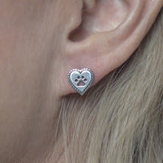 Heart with Paw Print Cut Out Post Earrings in Sterling Silver on Model.