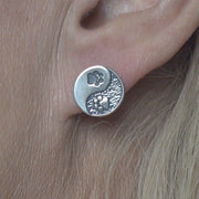 Paw Print Post Earrings with Yin and Yang Design in Sterling Silver on Model.